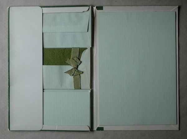 An opened folder of vintage German-made writing paper and envelopes.