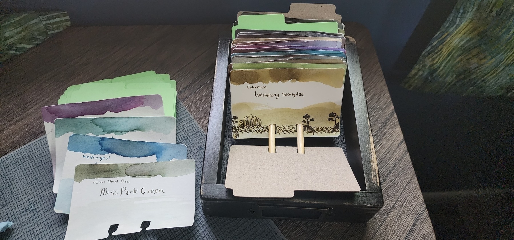 Short wooden tray with several col-o-dex cards with different color inks.