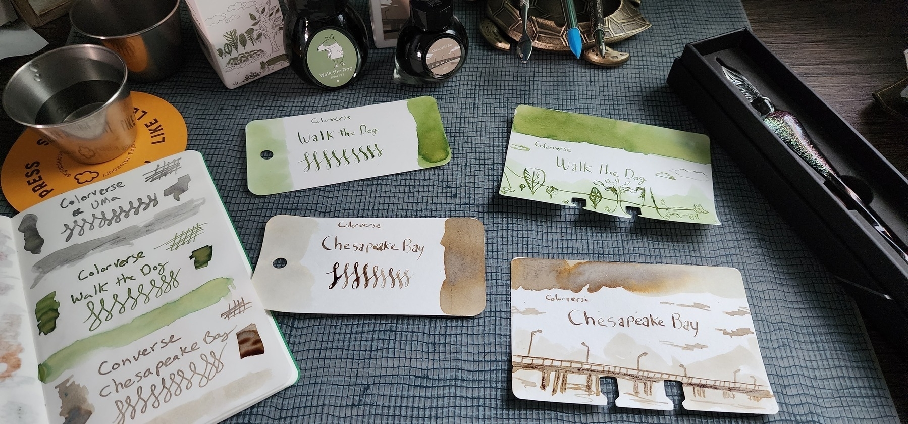 Color swatch cards and notebook for a yellow green ink and a light, warm brown ink