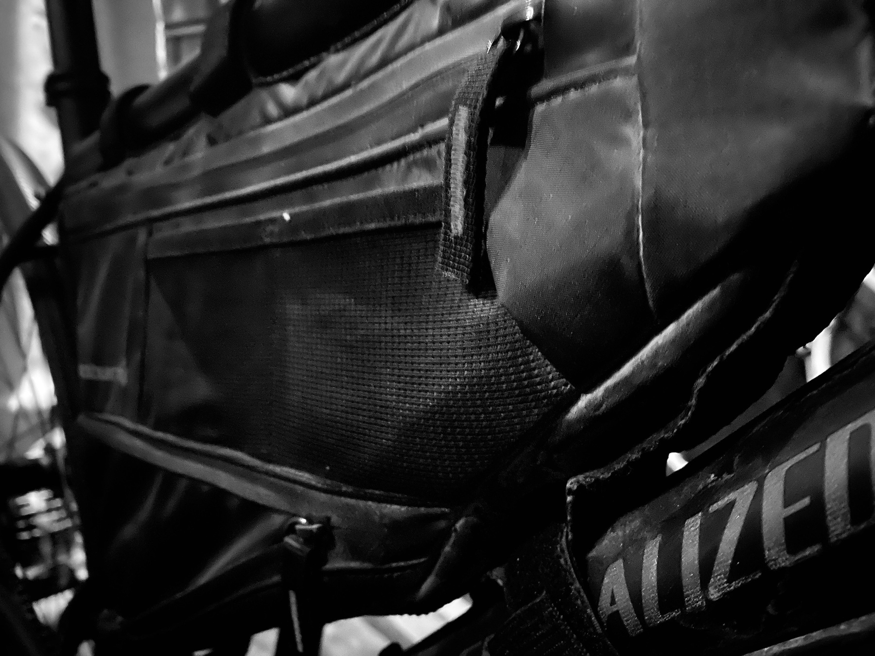 Black and white photo of a bike packing bags zippers. 