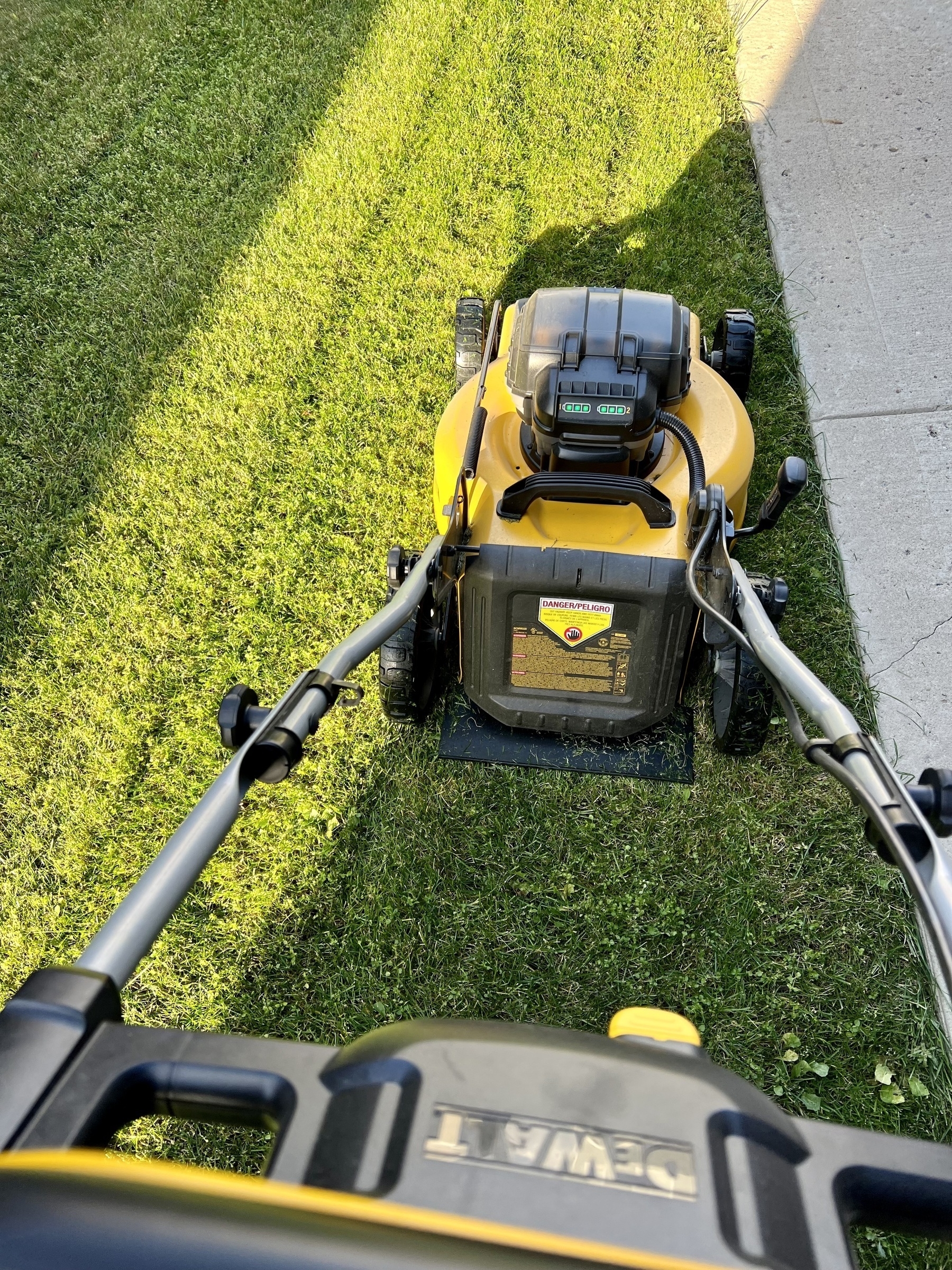 Photo of my lawn mower and cut grass. 
