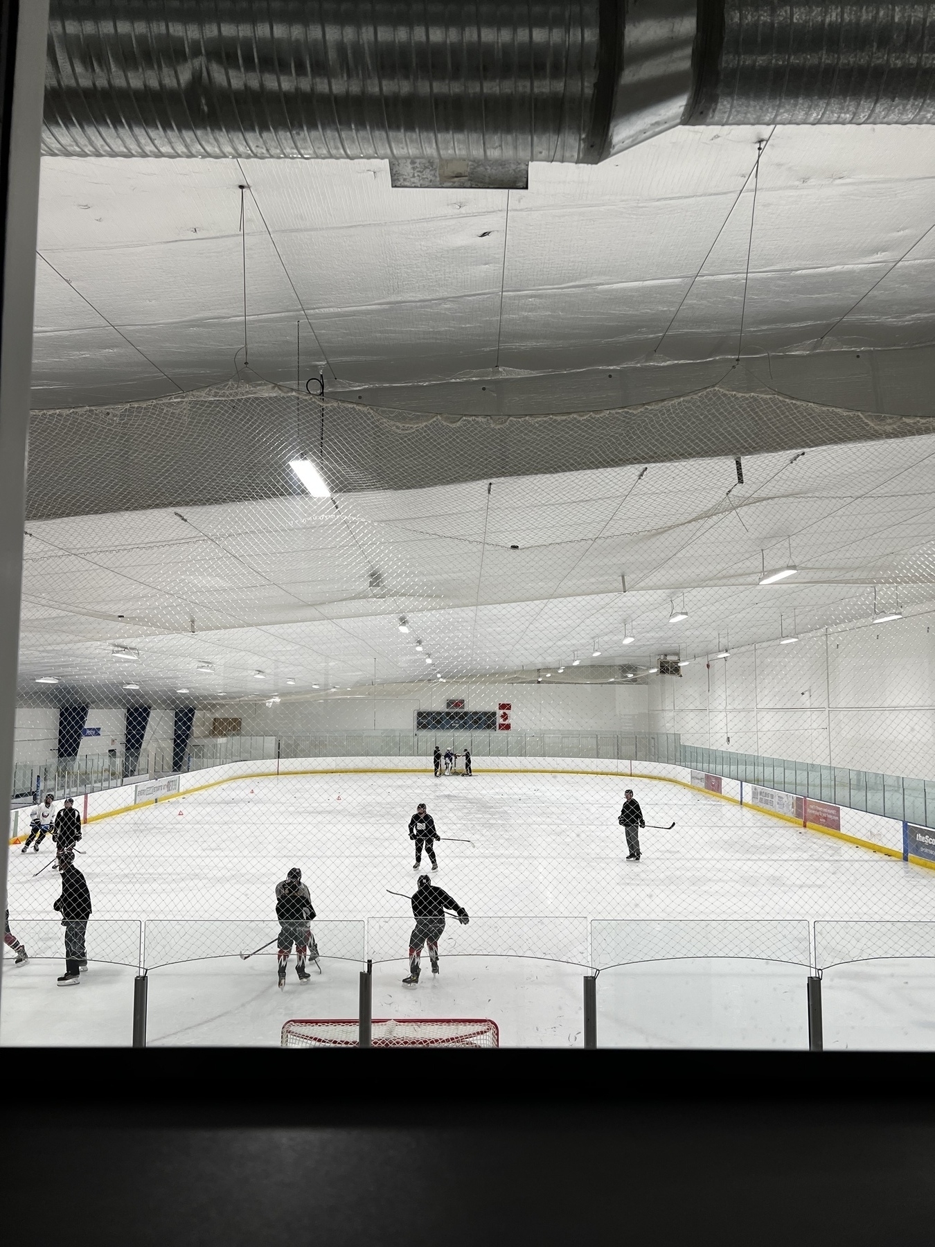 View of a hockey practice at an indoor rink. 