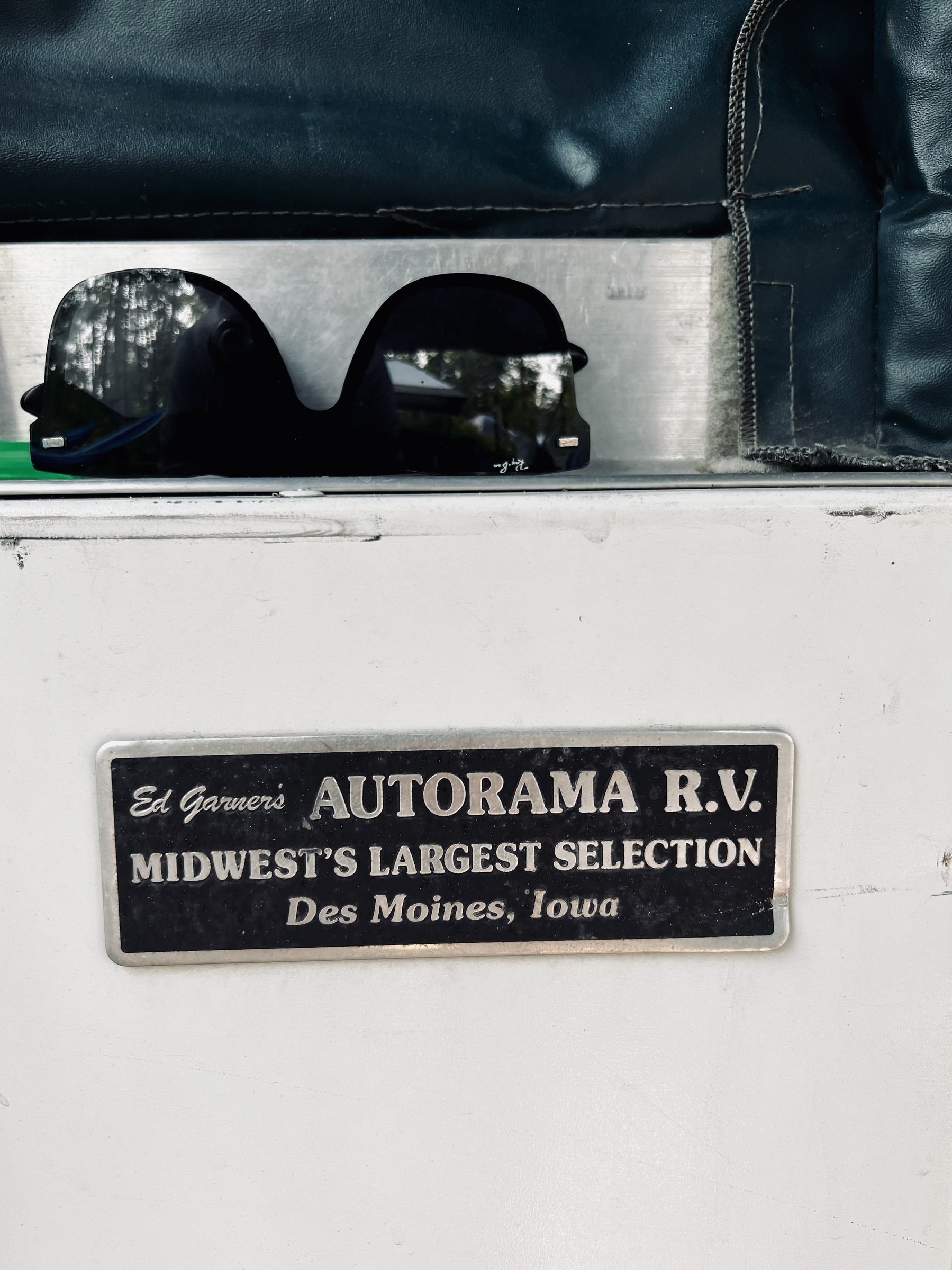 A sign on the side of a trailer that reads Ed Garner’s Autorama RV in Des Moines, Iowa