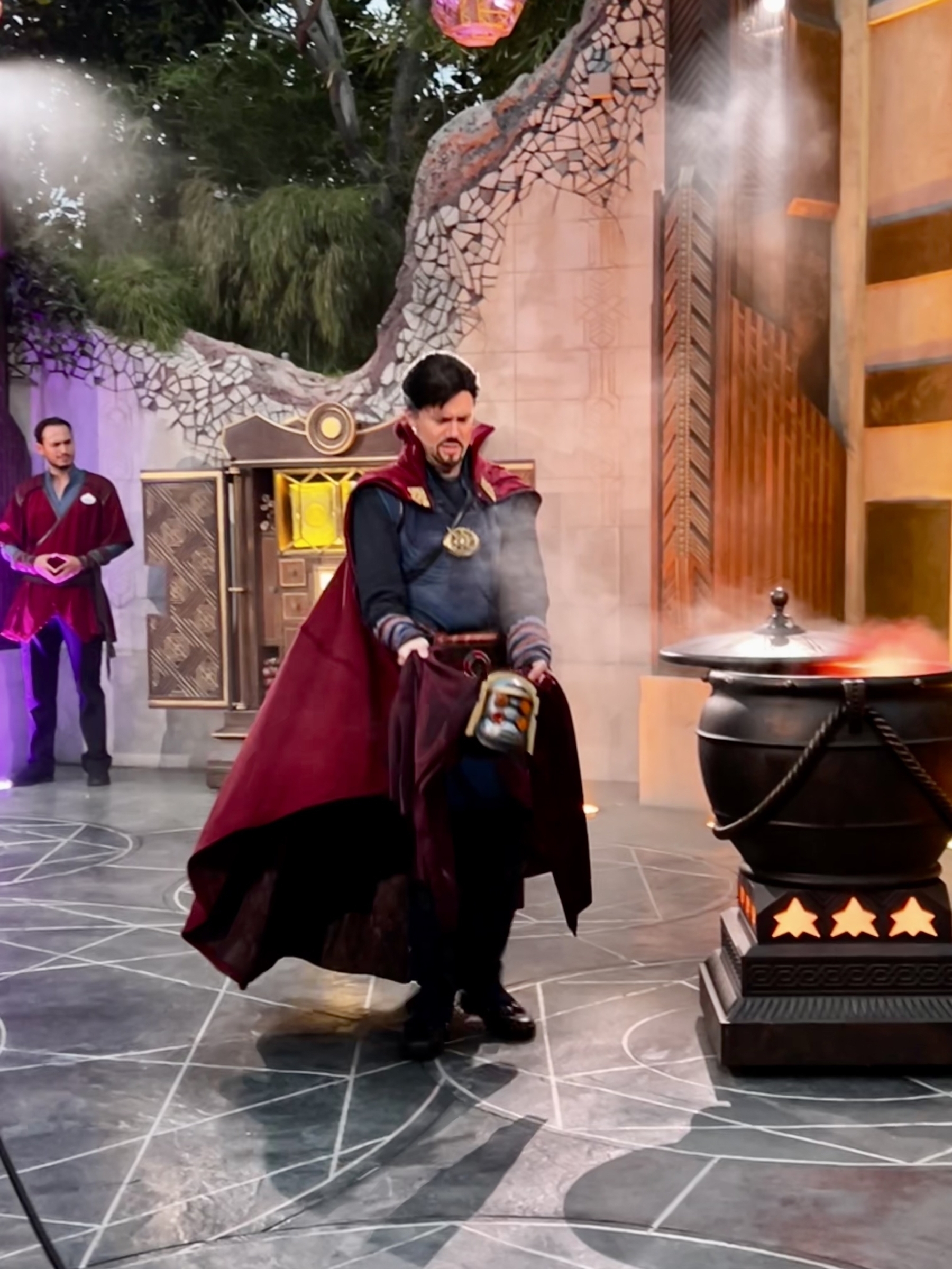 Dr. Strange at Disneyland carefully handling an object hes trying to not let loose into the crowd. 