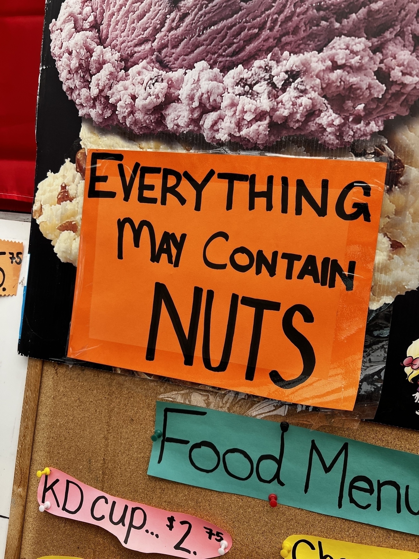 Sign from a ice cream shop that reads “everything may contain nuts”