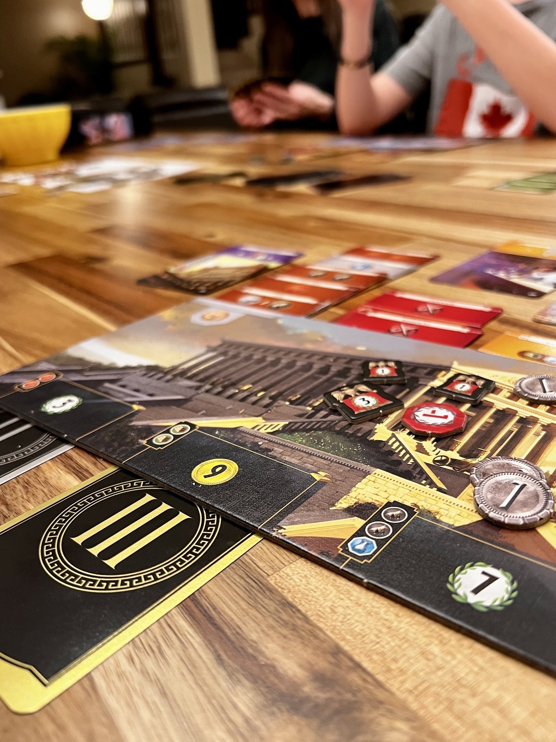 Closer up of a game of 7 Wonders being played. 