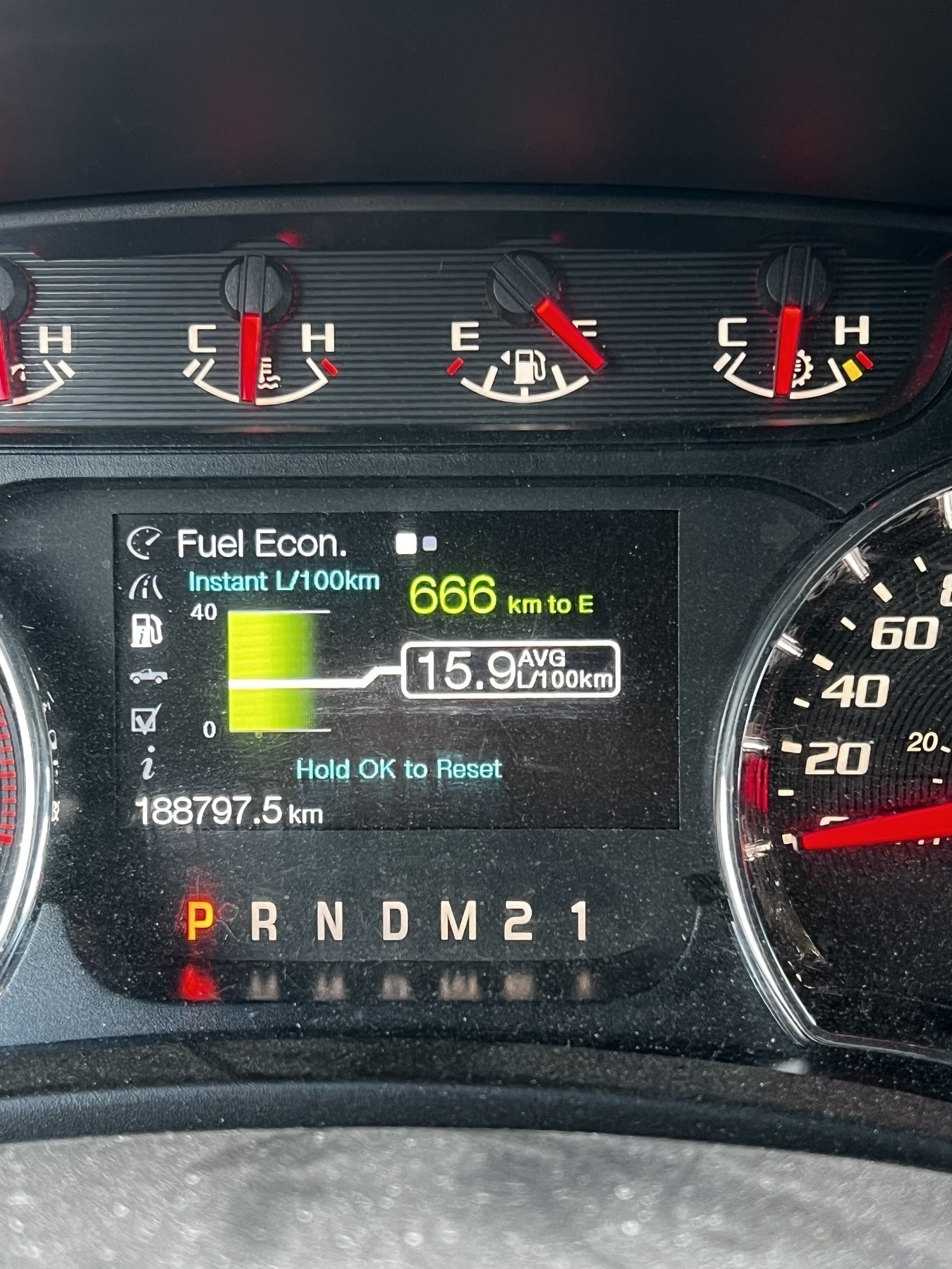 A car dashboard displays fuel economy statistics, including 15.9 L/100km average consumption, 666 km to empty, and the odometer reading 188797.5 km.