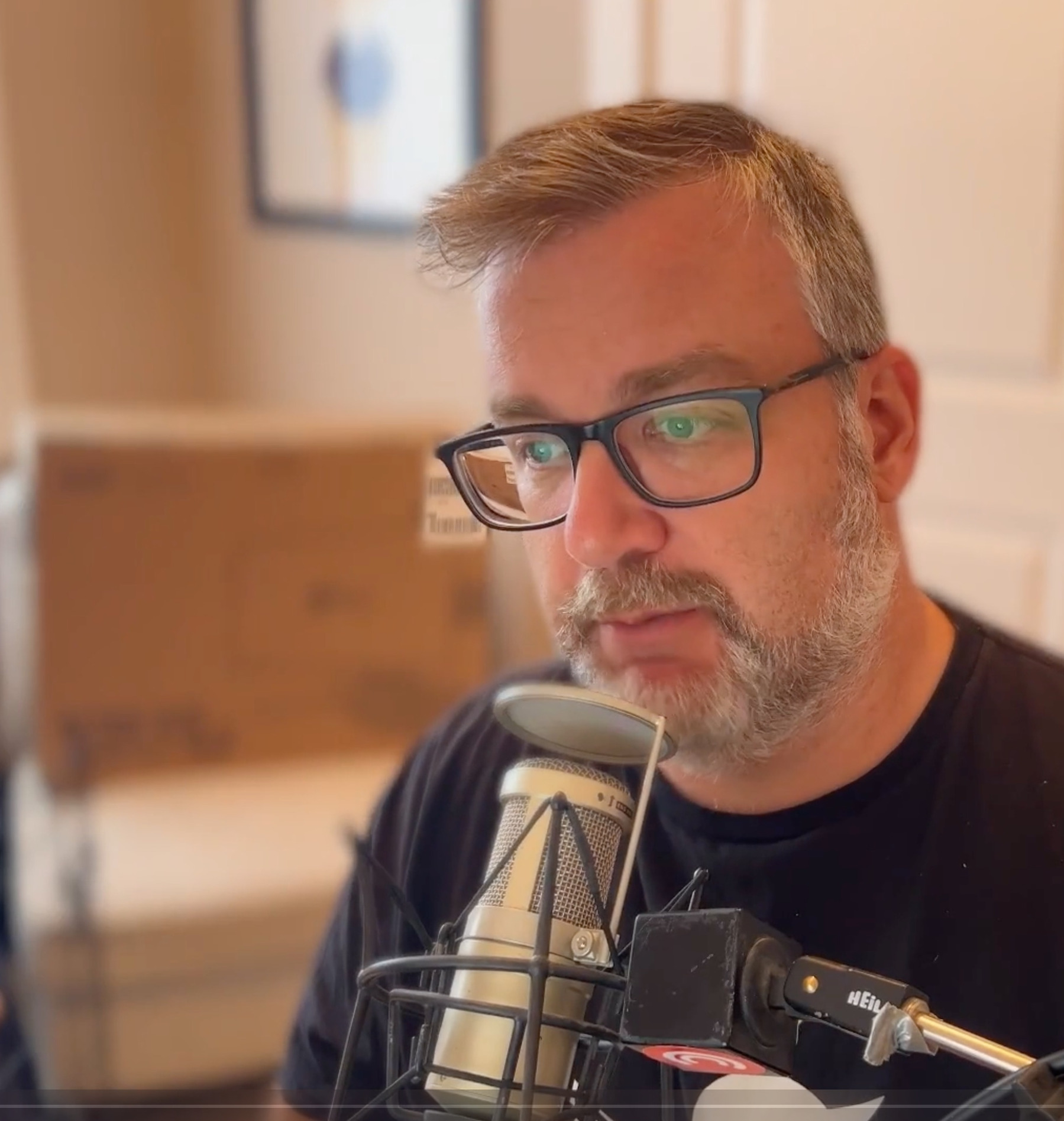 Me talking into a heil pr40 microphone, looking at a compuer screen. 
