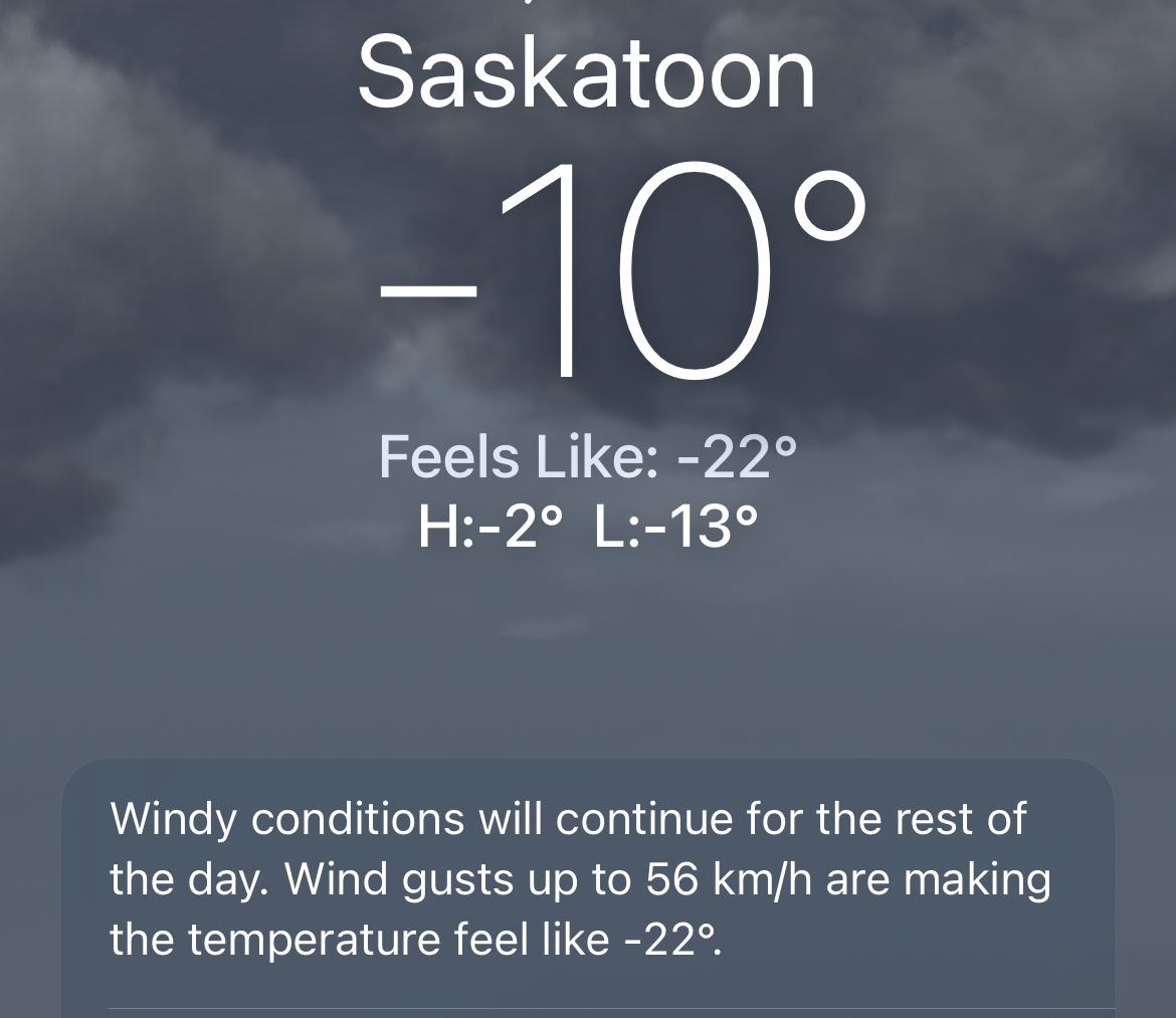 Weather report for Saskatoon showing a temperature of -10°C, with a feels-like temperature of -22°C and strong wind conditions expected.