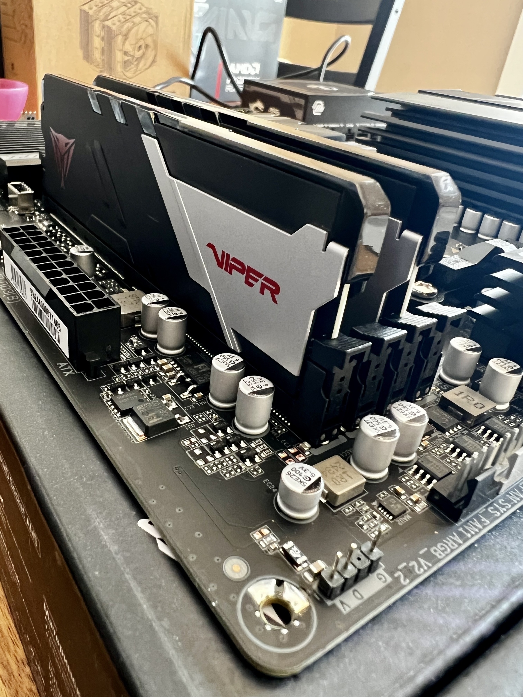 A closeup of a computer motherboard with RAM installed. 