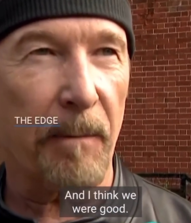 A man wearing a black beanie and jacket stands in front of a brick wall with the text THE EDGE and the subtitle And I think we were good. displayed on the screen.