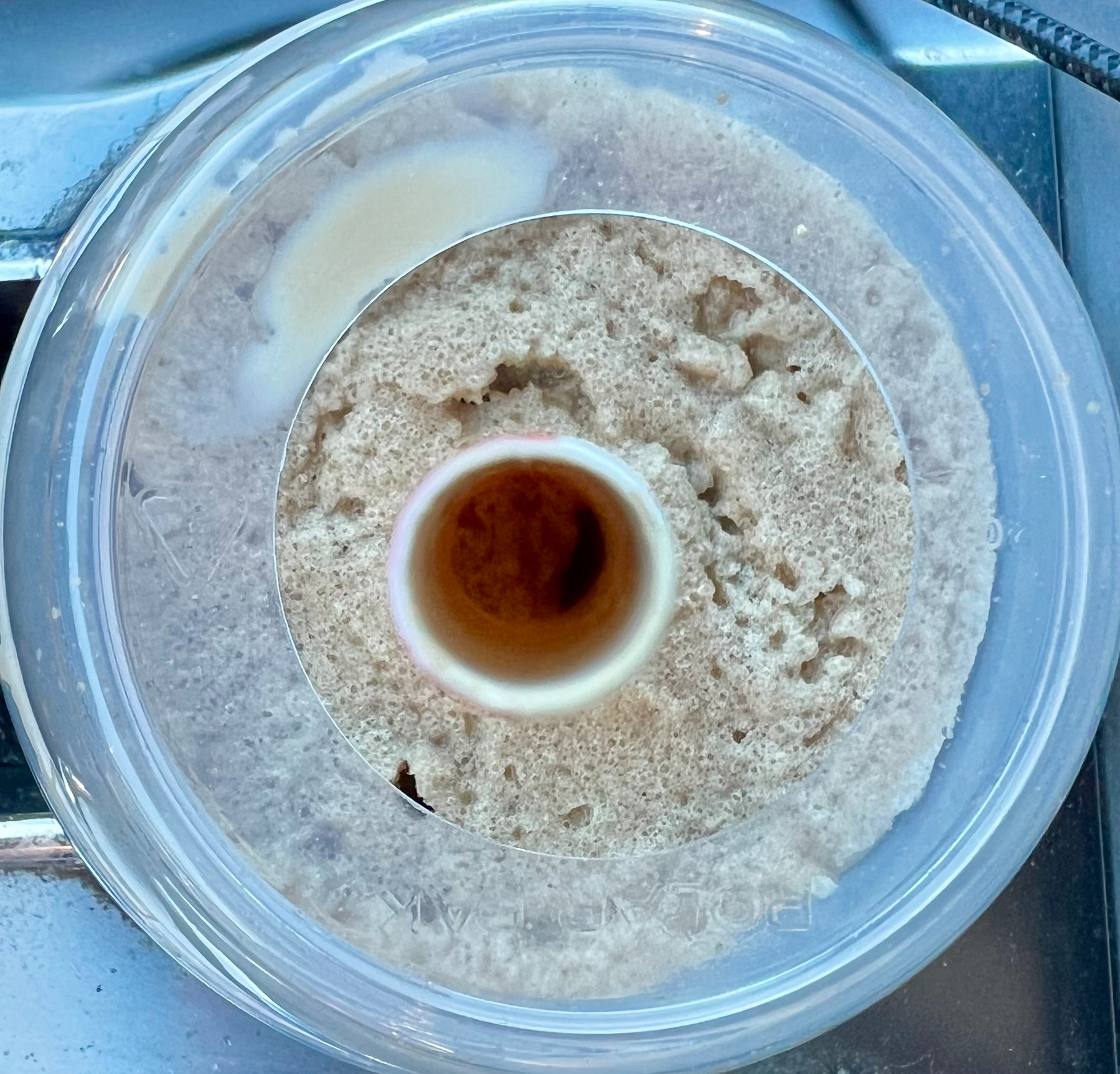 A close-up view of an iced Capp from tim Hortons viewing down the straw. 