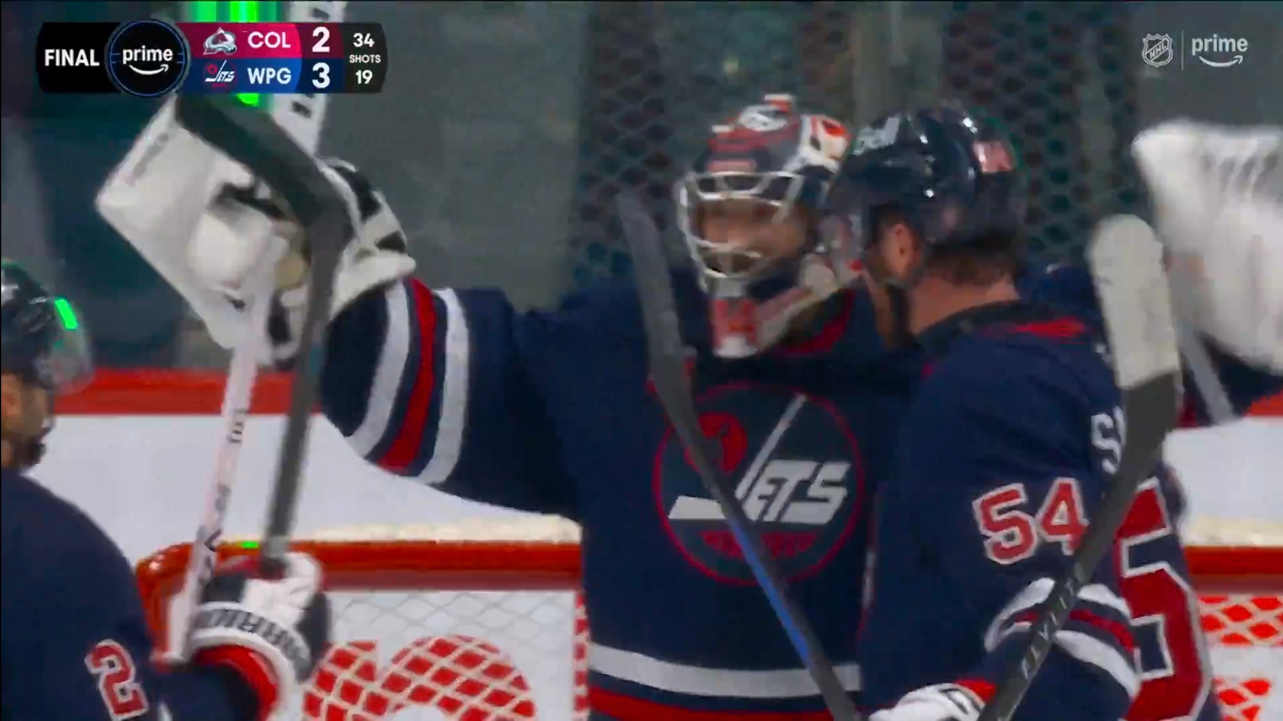 Players from the Winnipeg Jets hockey team are celebrating a win during a game against the Colorado Avalanche.
