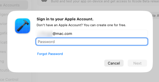 A login prompt requests the user to sign in to their Apple Account by entering their email address and password.