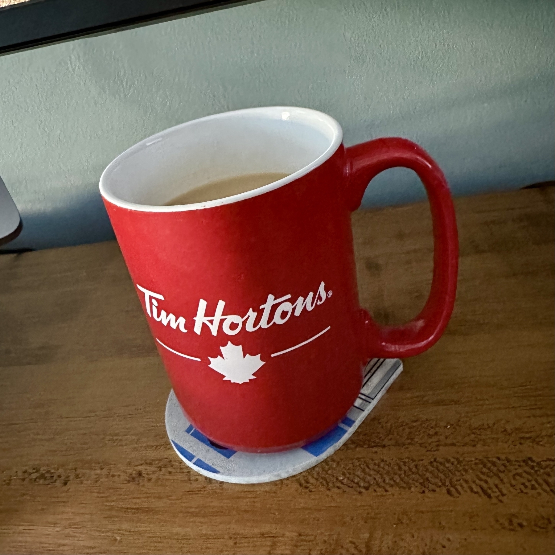 A mug of tea on a desk.