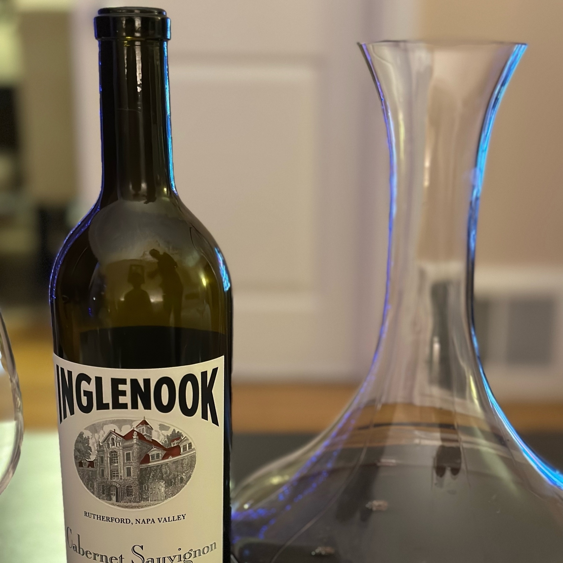 a bottle of 2013 Inglenook Cabernet Sauvignon and the wine poured in a decanter. 