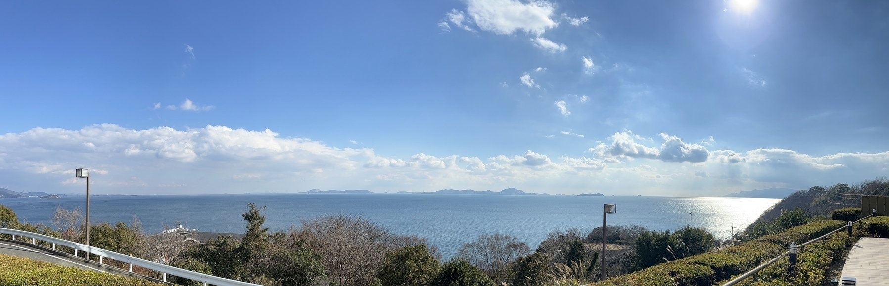 Panorama of the sea from high up. Some small uninhabited islands are across the way