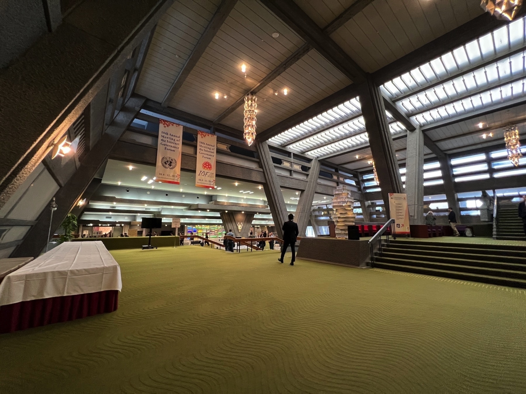 Inside of the main KICC lobby with the green carpet and not-so-accessible staircases everywhere
