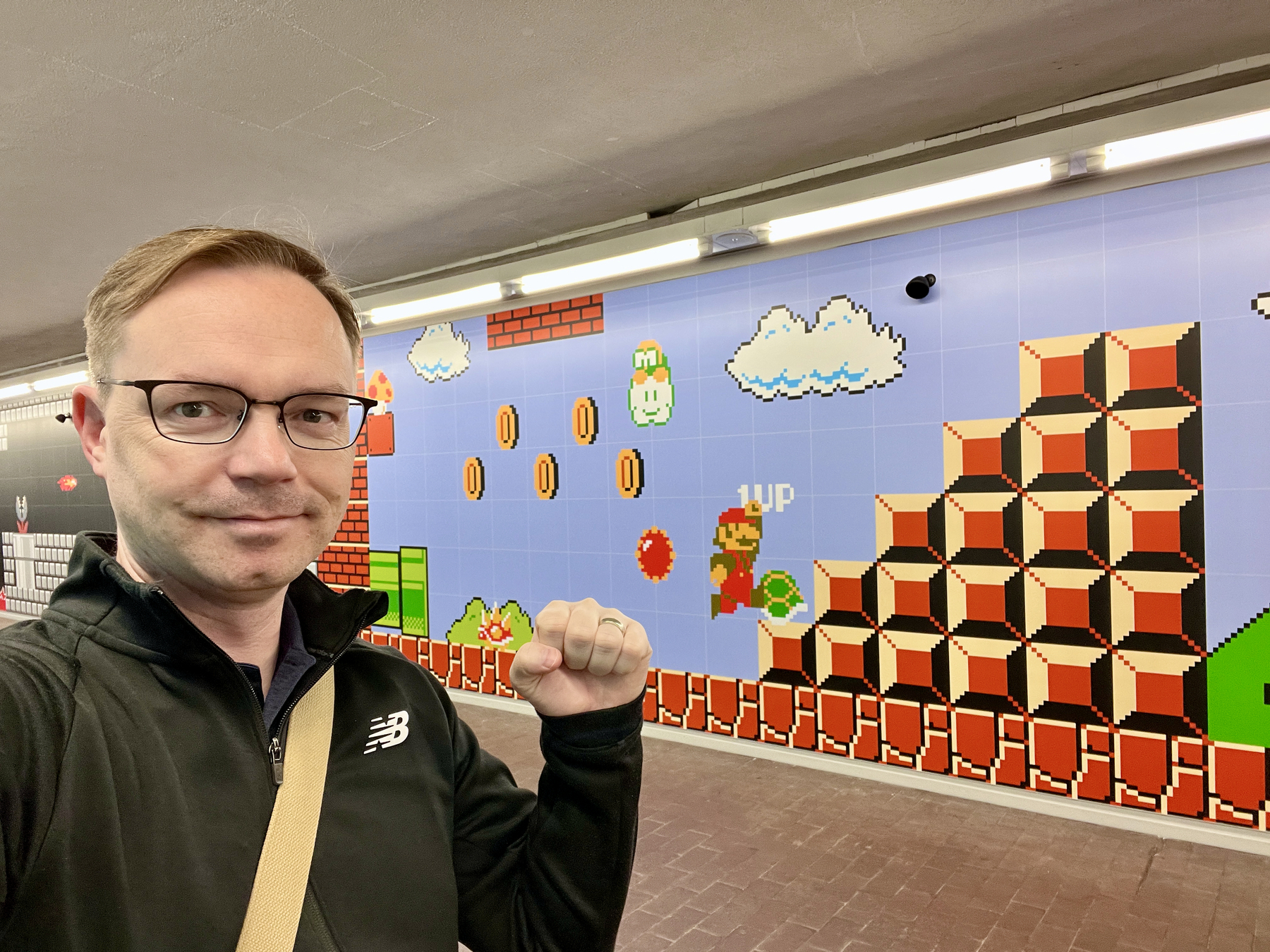 Chad selfie in front of a wall with Super Mario jumping up steps