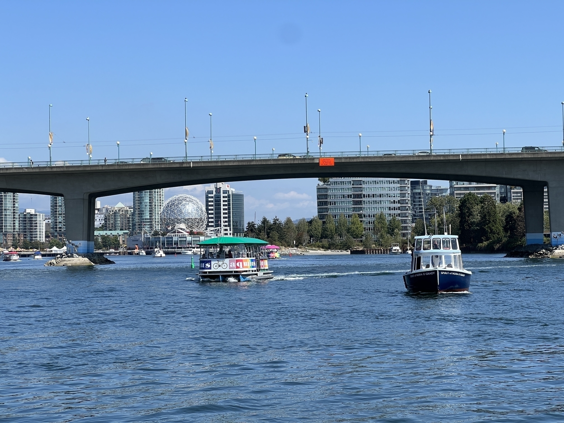 Water taxi on False Creek with Science World in the background 