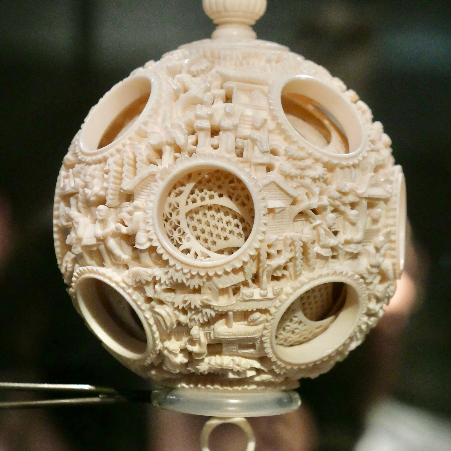 Intricately carved ivory ball with large holes revealing more layers inside
