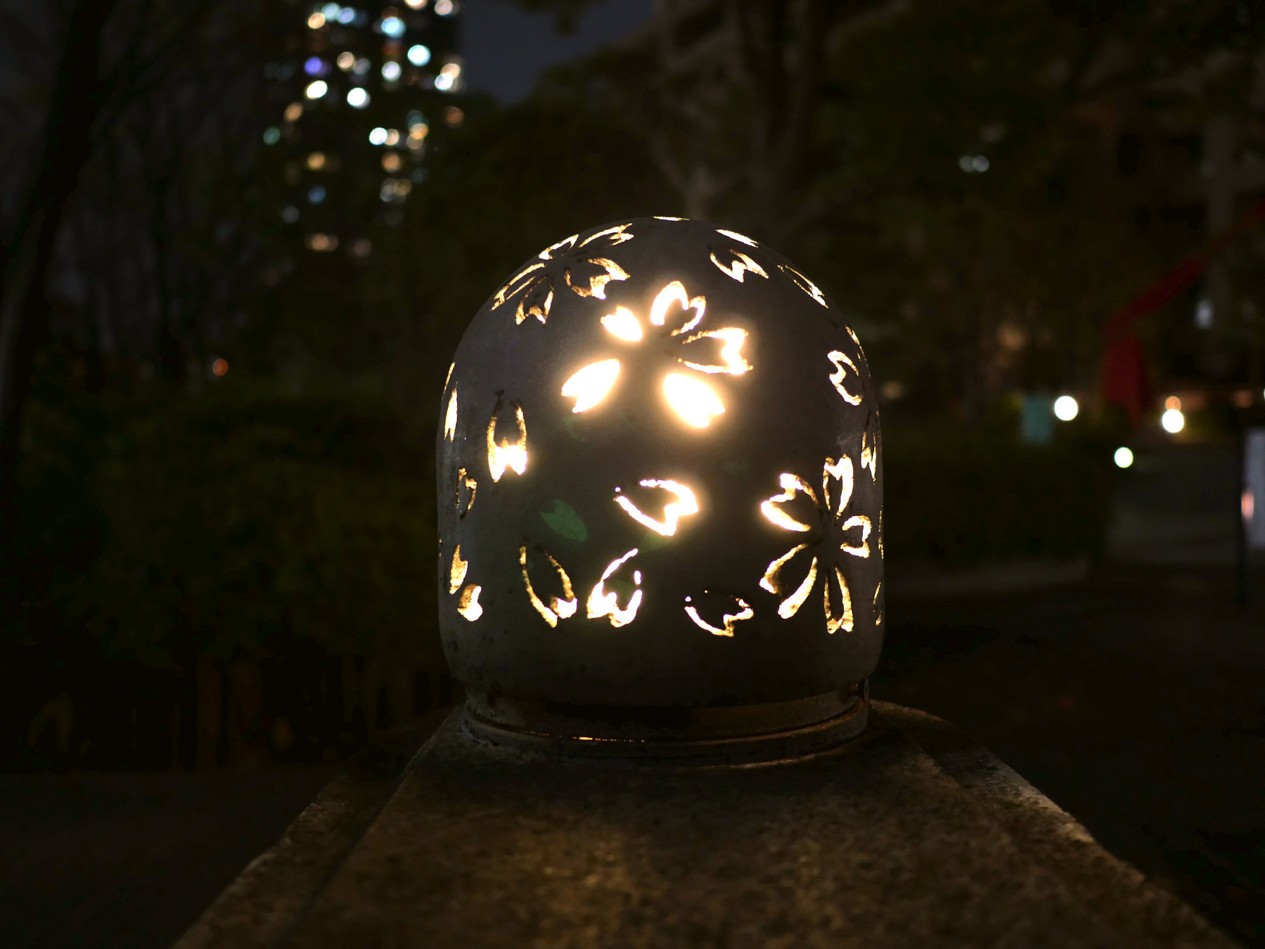 a cover over a street light with sakura motif