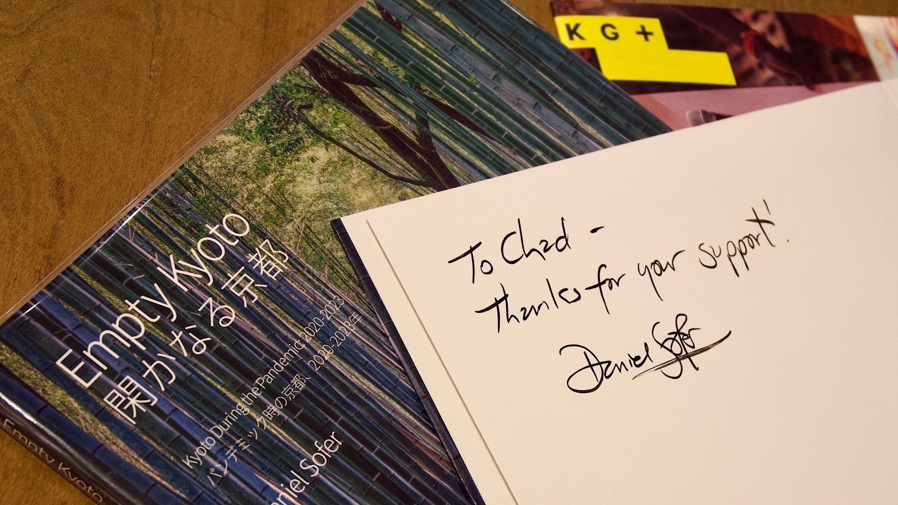 Daniel signed the inside cover of Chad’s book: “To Chad - Thanks for your support”. In the background is a pamphlet for Kyotographie
