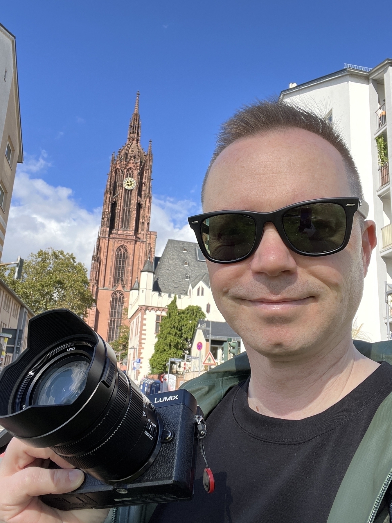 Chad poses with camera in front of Frankfurt Cathedral