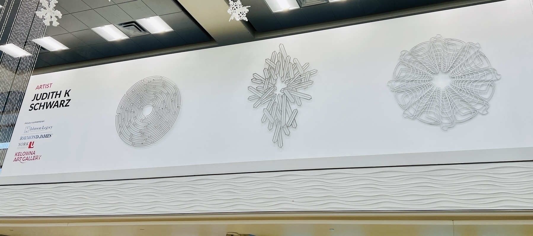 Judith K Schwarz’s art installation at the airport featuring large handmade snowflakes