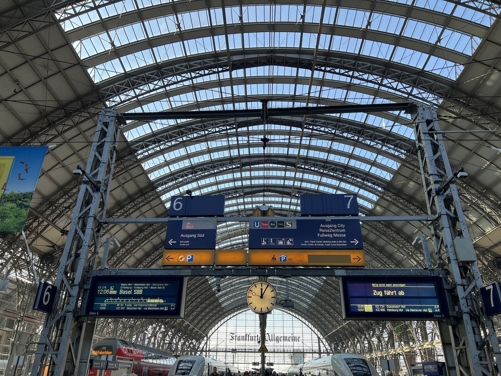 Inside Frankfurt main station with signs indicating trains headed to different destinations across Germany