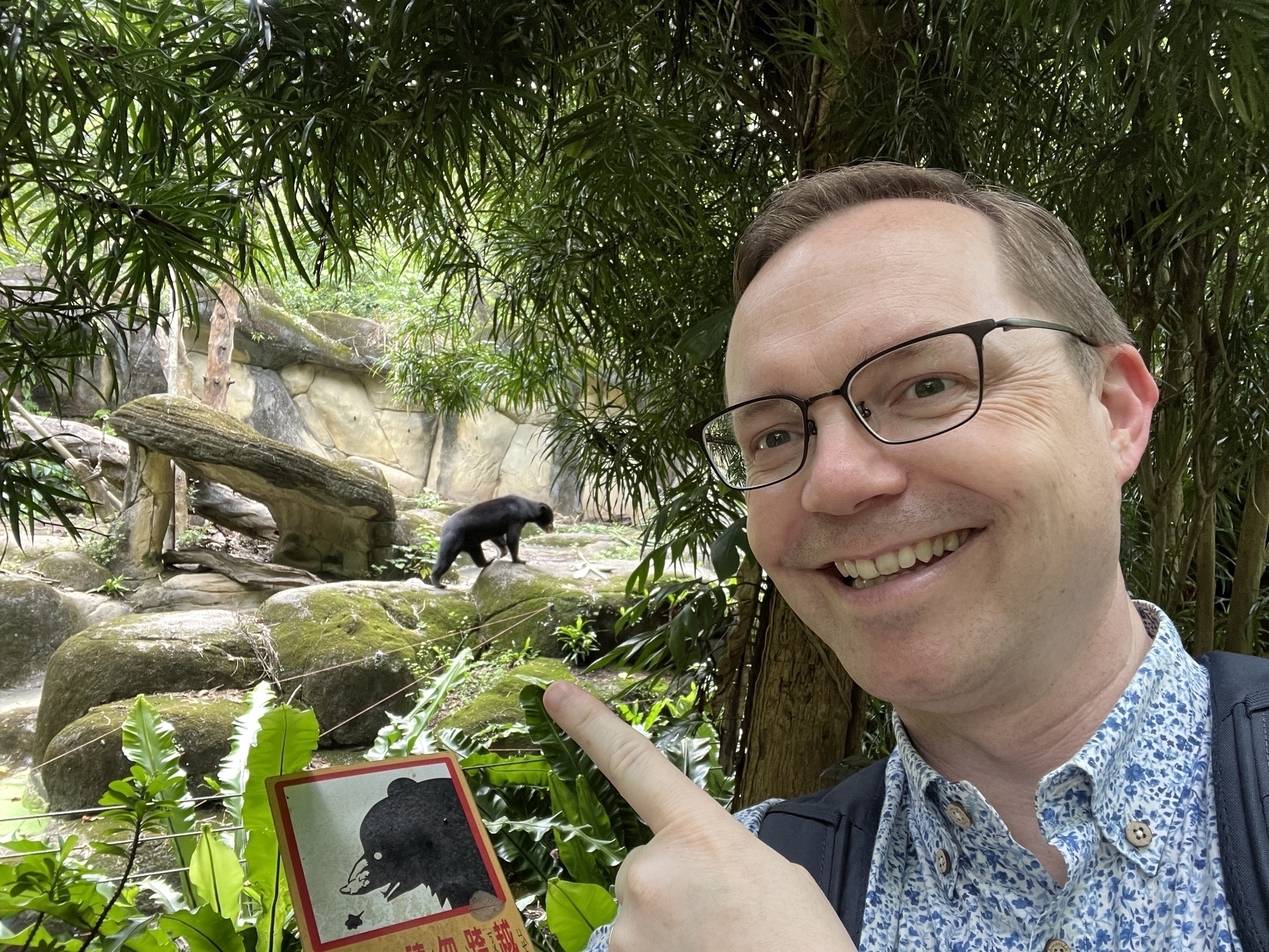 Chad selfie with a sun bear in the distance