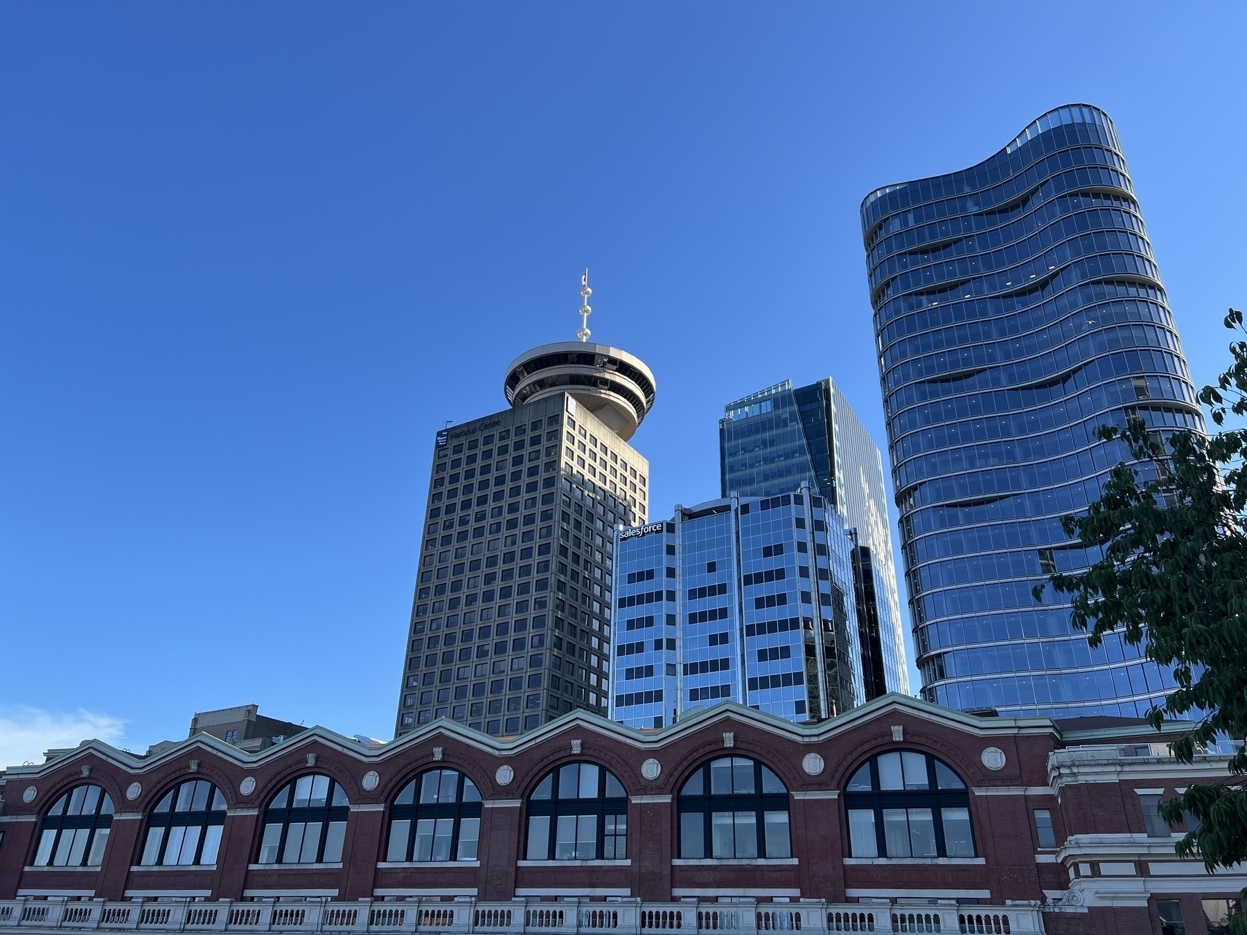 Harbour Center against a perfect blue sky. In the foreground Waterfront Station