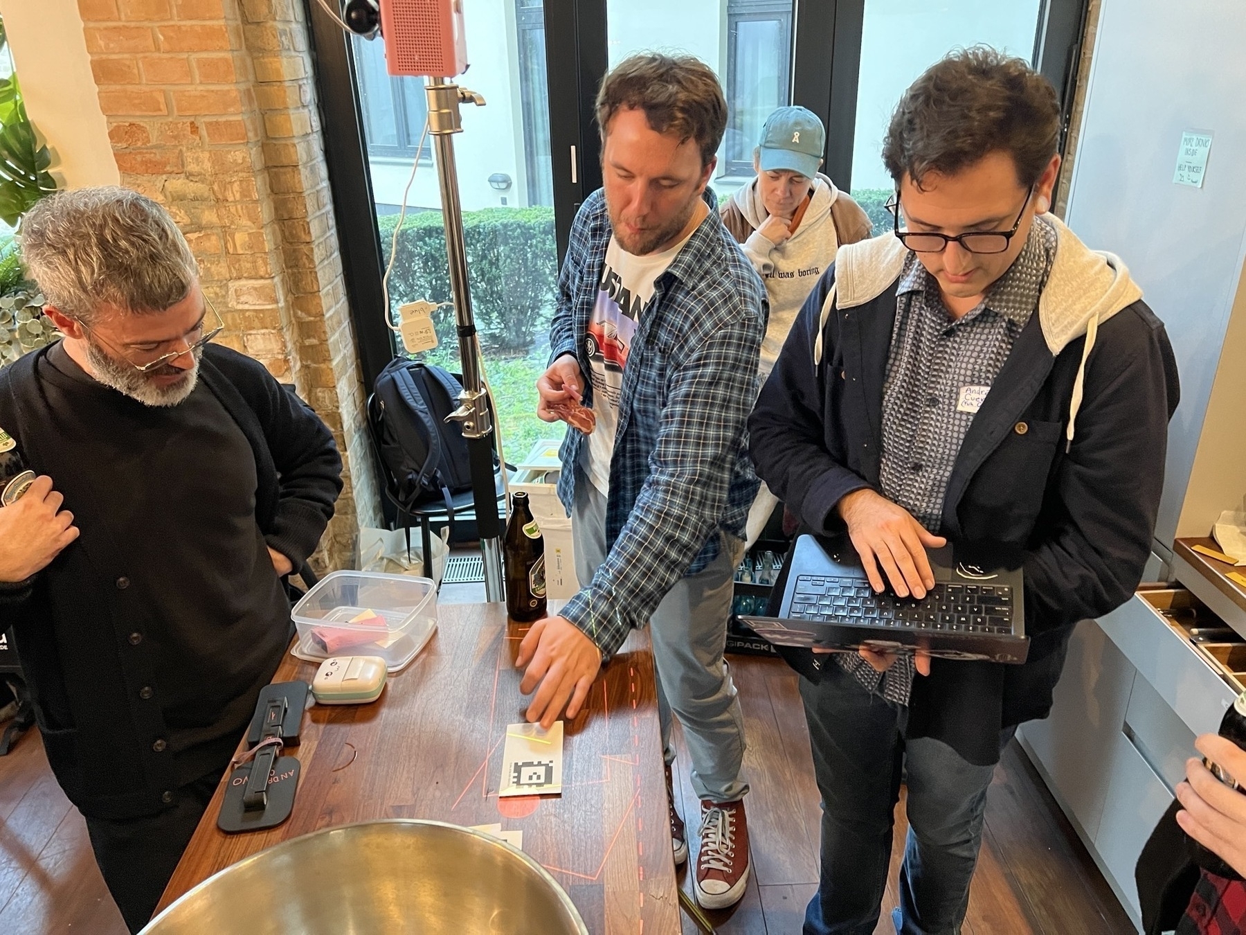 People playing with the paper-and-projector-based Folk Computer