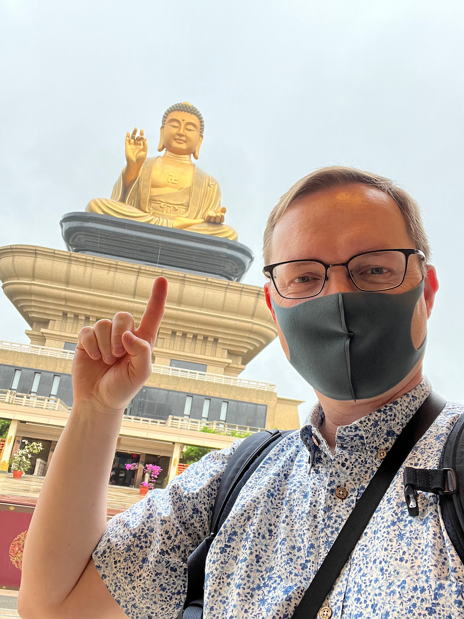 Chad selfie pointing at the Buddha statue from much closer