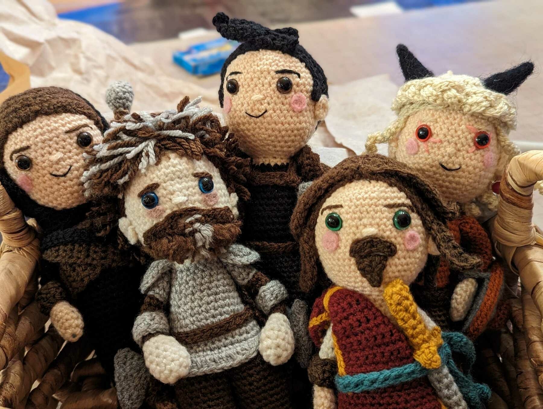 5 crocheted smiling dolls with armour and swords