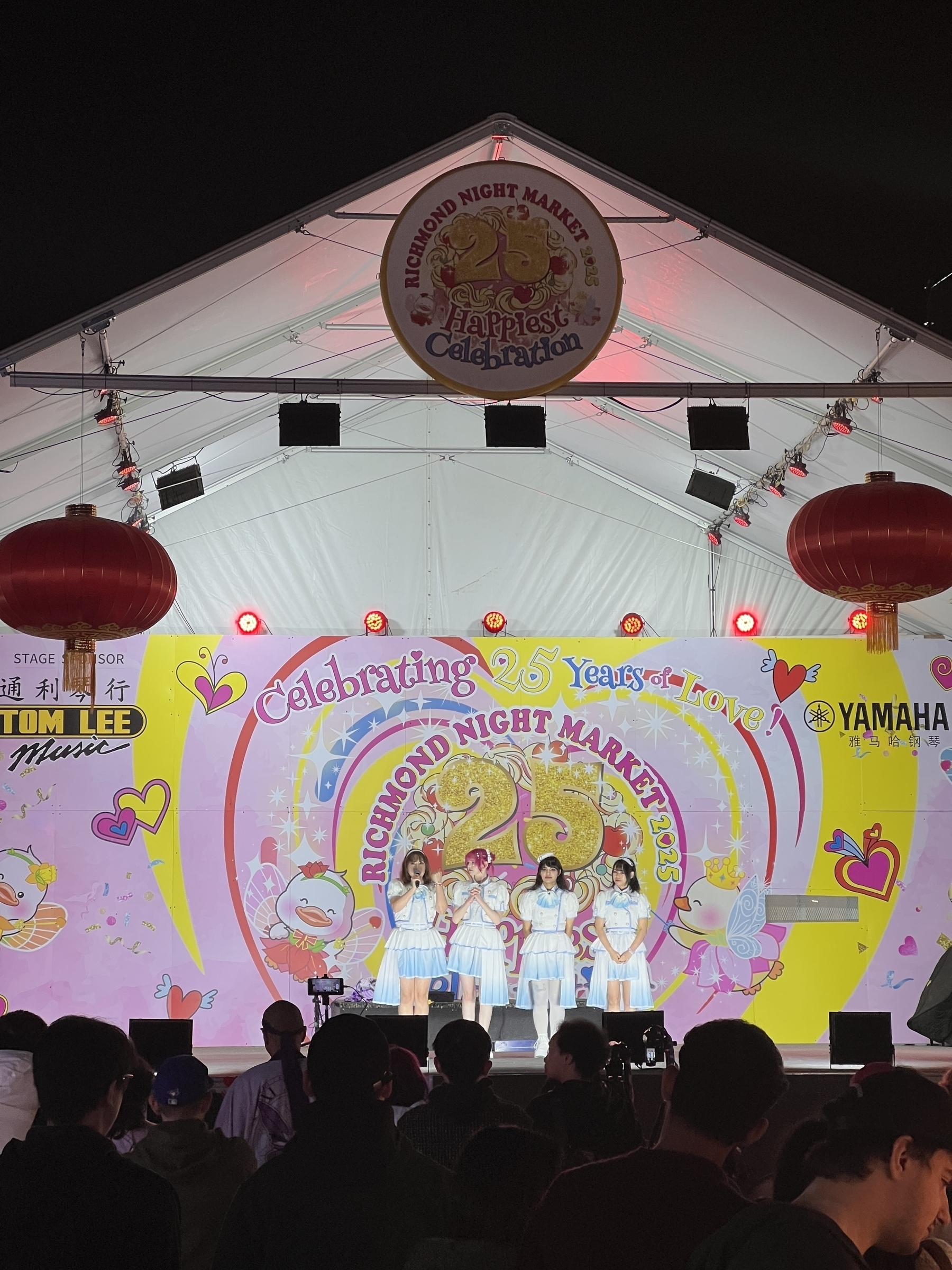 An idol group thanks the crowd before performing on stage