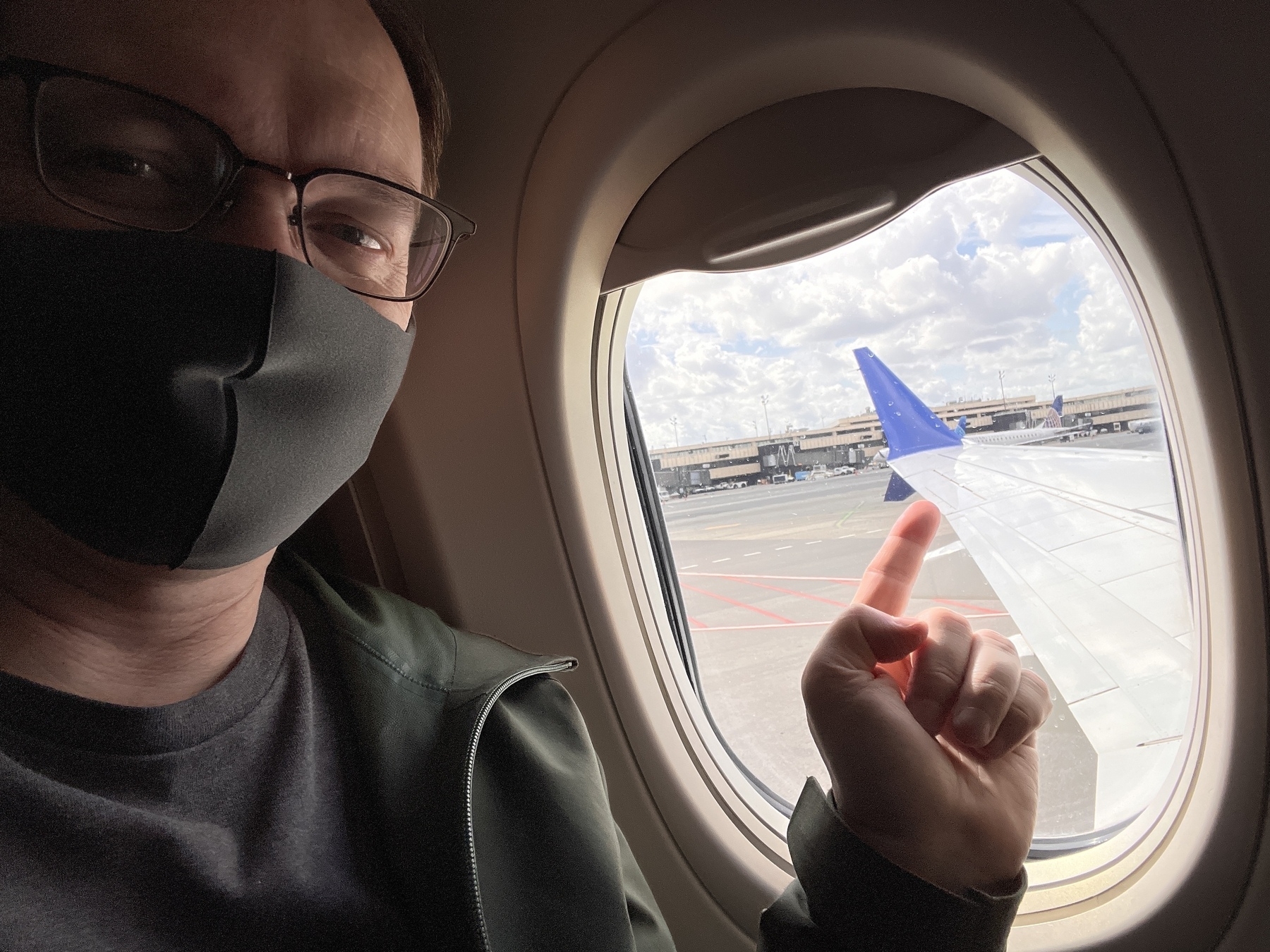 Chad inside the plane points at the wing outside the plane