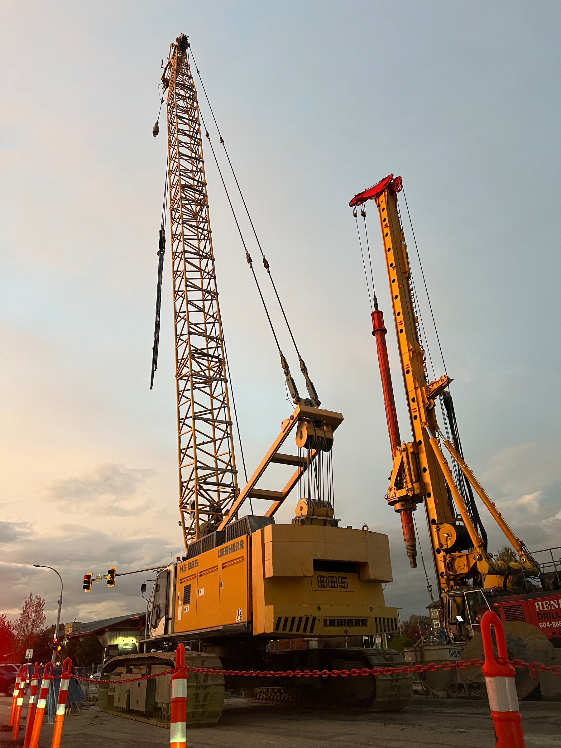 An massive crane rolls along beside the highway where the new SkyTrain station is being built