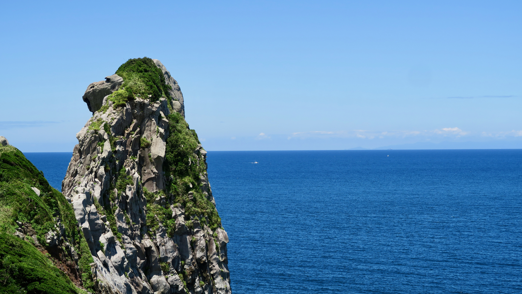 Saruiwa, the Monkey Rock of Iki. A 40m tall rock formation that looks like a giant monkey. In the background is the open, blue sea