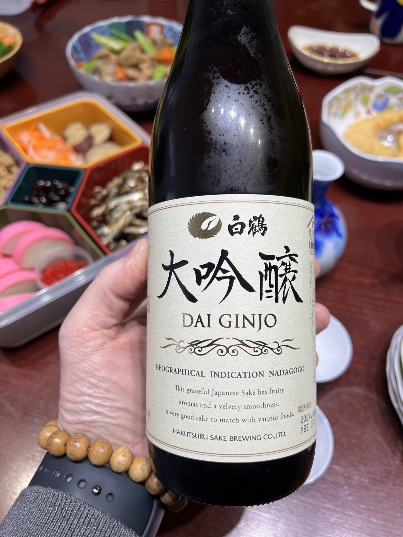 A bottle of Daiginjo with English labels! In the background is osechi