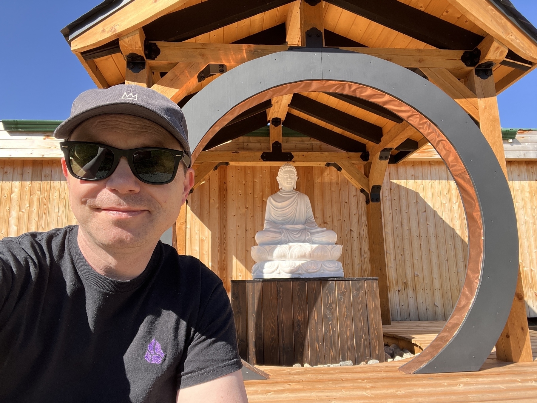 Chad selfie outdoors with a large white Vietnamese statue of the Buddha sitting on a lotus leaf