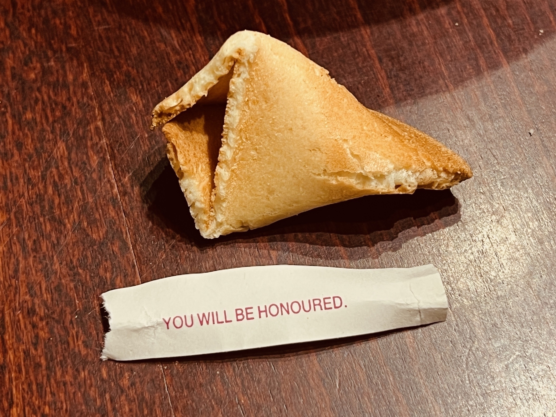 Half a fortune cookie and a strip of paper with the words: YOU WILL BE HONOURED.