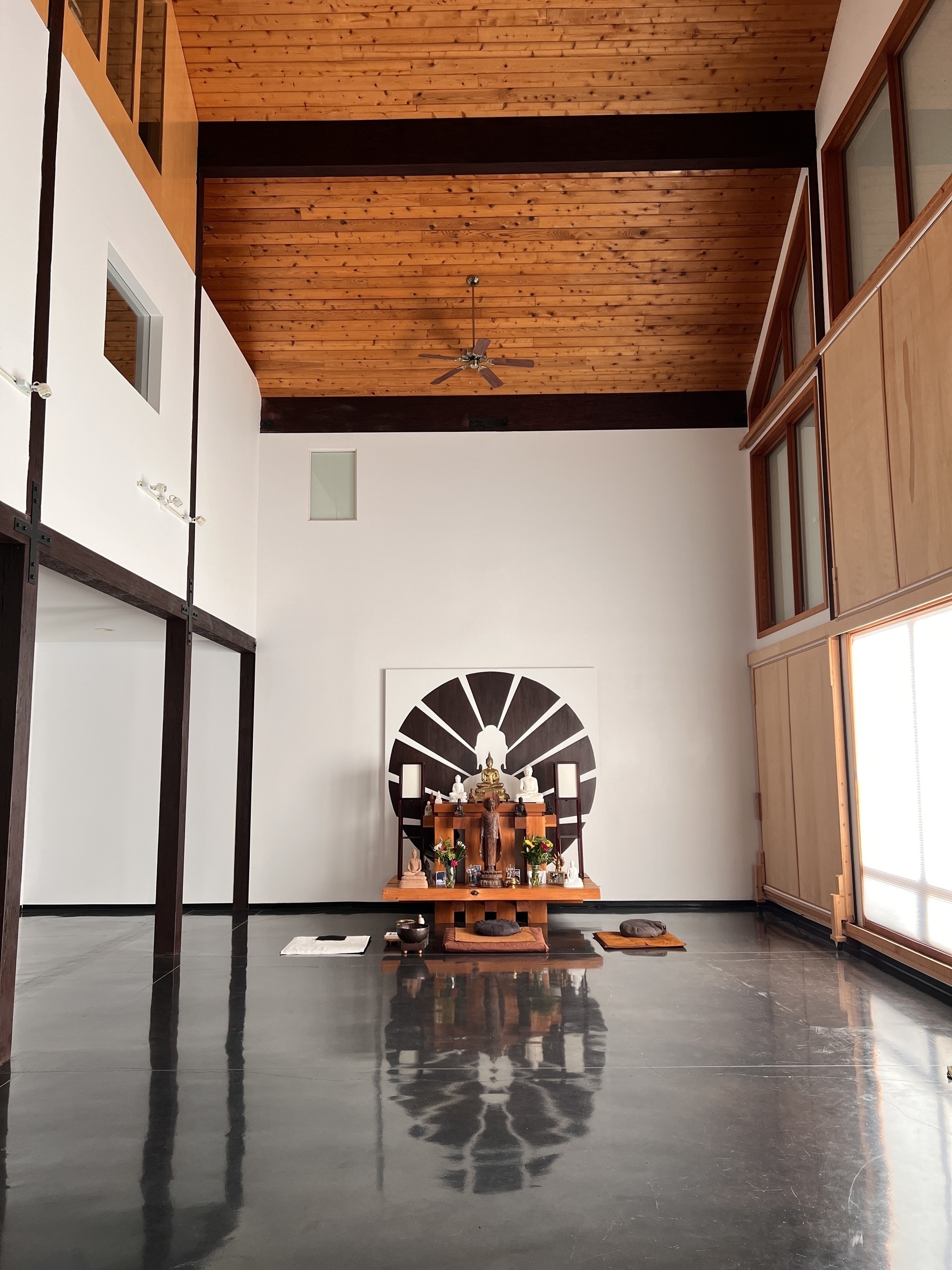 A meditation hall with an altar full of Buddha statues