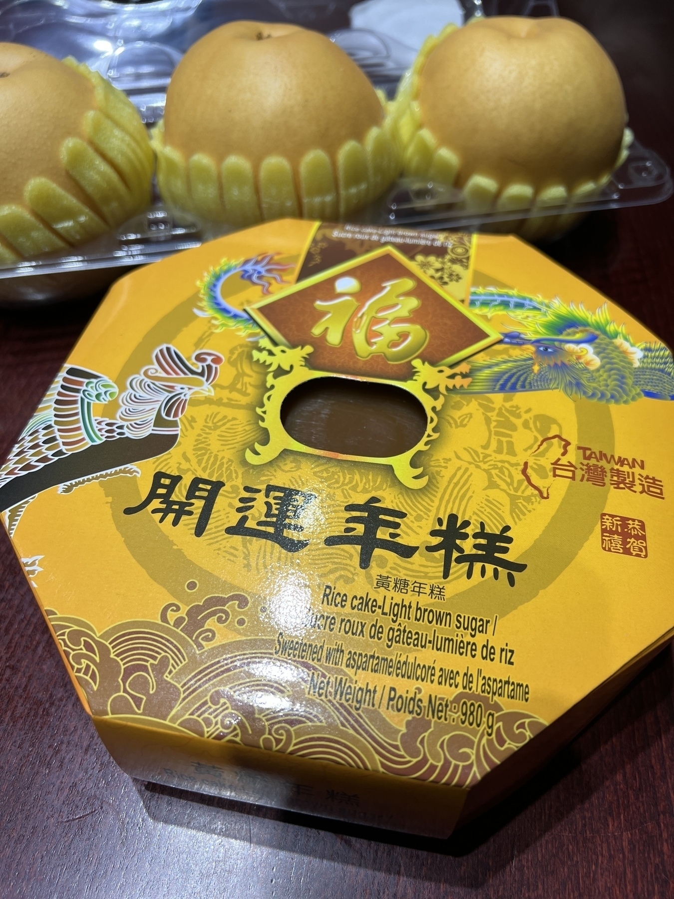 A box of Taiwanese rice cake with Asian pears in the background 