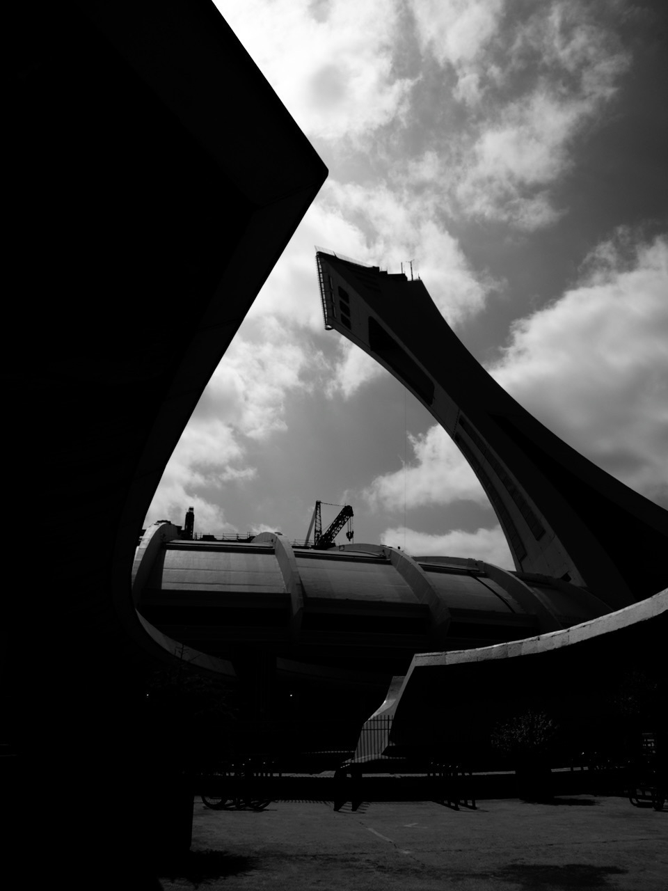 Black and white image of Montreal tower vaulting over the Montreal Stadium which is technically BESIDE the Biodome