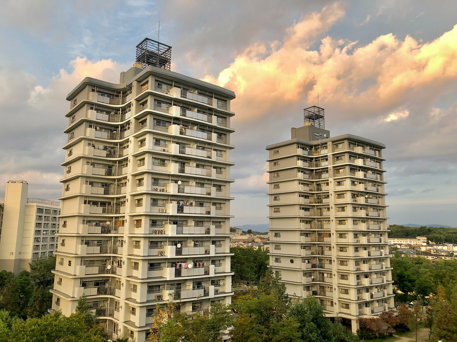Older apartment buildings, about 15 storeys tall,  against an evening cloudy sky