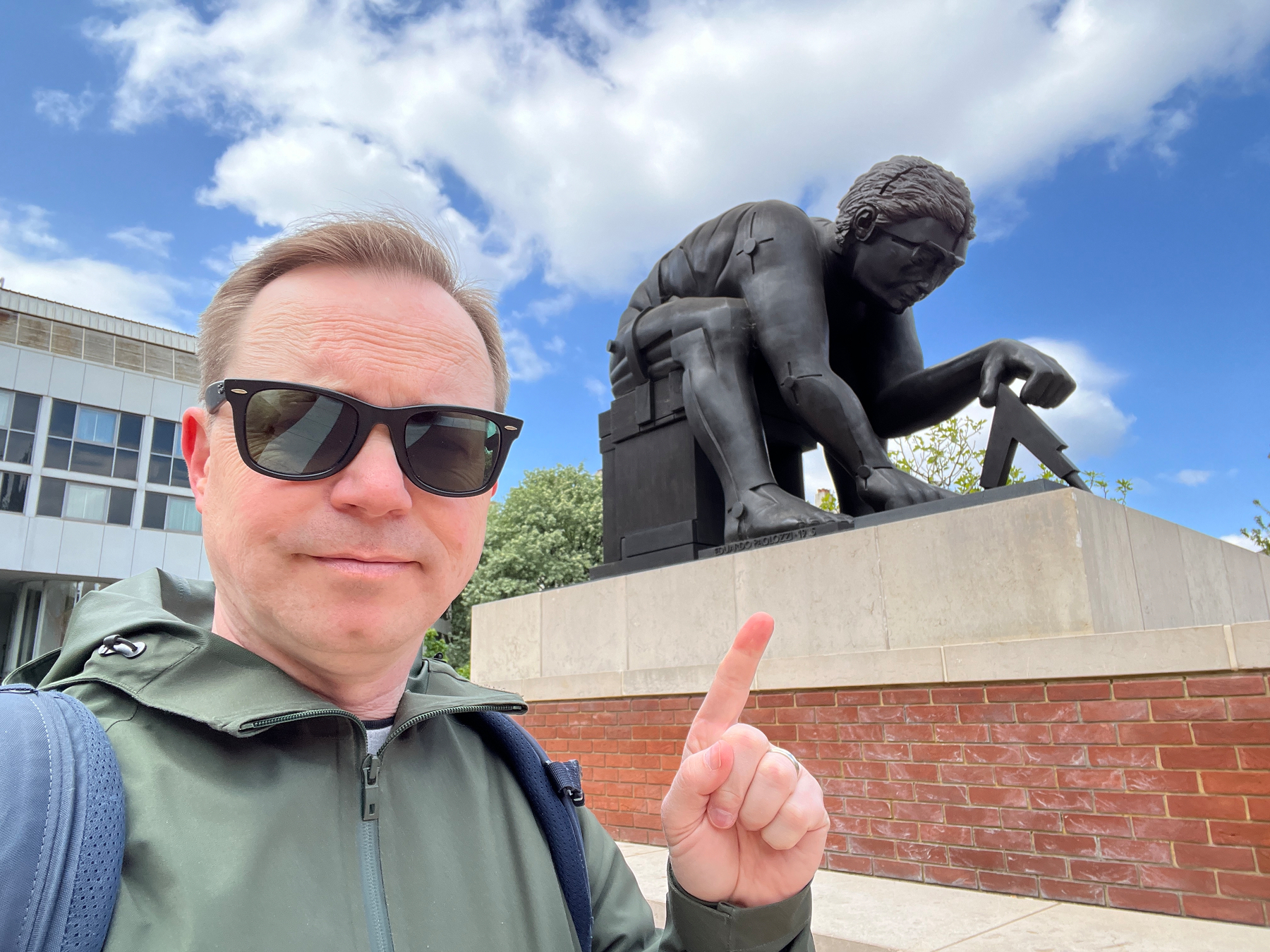 Chad selfie pointing to Isaac Newton statue by Eduardo Paolozzi
