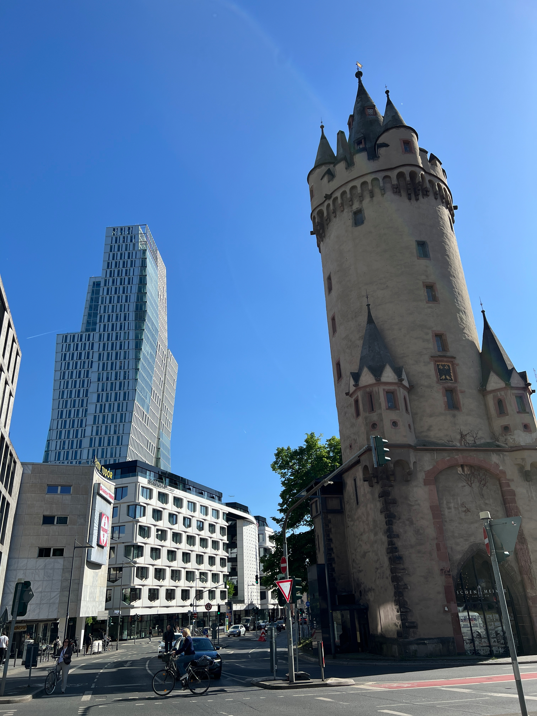 A modern tower in the background and the 15th C Eschenheimer Turm tower