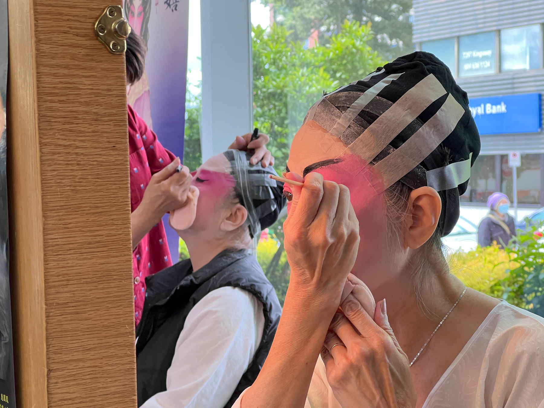 Performers putting on makeup