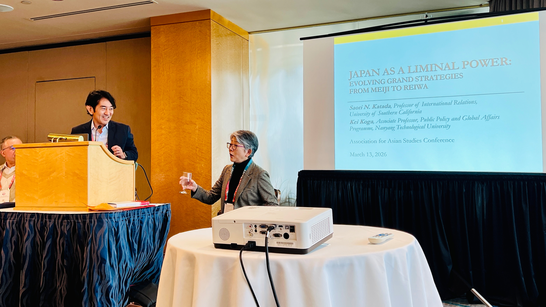 Kei Koga and Saori Katada discuss at the podium while a slide is projected on the screen titled “Japan as a Liminal Power”